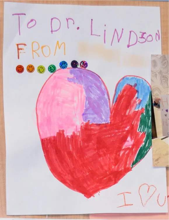 A child’s drawing to Dr. Lindzon of a big coloured heart with smiley-face stickers and “I love you”