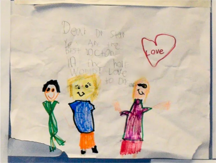 A child’s drawing that reads “Dear Dr. Star, you are the best doctor in the whole world” with three smiling people and a heart